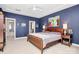 Serene bedroom boasts striking blue walls, soft carpet, and windows that bring in natural light at 1244 Madison Towns Ln, Charlotte, NC 28209