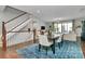 Dining area with modern furnishings, open to living space with hardwood floors and natural light at 1244 Madison Towns Ln, Charlotte, NC 28209