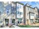 Stately brick townhome showcases a three-story facade with well-maintained landscaping at 1244 Madison Towns Ln, Charlotte, NC 28209