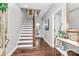 Inviting foyer features hardwood floors, a staircase with white risers, and neutral wall paint at 1244 Madison Towns Ln, Charlotte, NC 28209