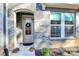 Charming brick home featuring a welcoming arched entryway, decorative wreath, and vibrant potted flowers at 1244 Madison Towns Ln, Charlotte, NC 28209