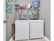 Functional laundry room equipped with a washer, dryer, and shelving for storage at 1244 Madison Towns Ln, Charlotte, NC 28209