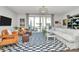 Inviting living room with a checkered rug, modern seating, and access to outdoor space at 1244 Madison Towns Ln, Charlotte, NC 28209