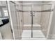 Modern shower with tiled walls, glass door, built in seating and convenient shower accessories at 1244 Madison Towns Ln, Charlotte, NC 28209