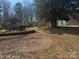 Unkept backyard with outbuildings and overgrown landscaping, a blank canvas to create your dream oasis at 128 Trexler Ave, Mount Holly, NC 28120
