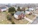 Sprawling home features a charming brick and white facade, beautifully landscaped grounds, and a multi-car garage at 13132 Purple Dawn Dr, Charlotte, NC 28213