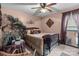 A bedroom is well-decorated with a plush bed, a ceiling fan, and natural light to create relaxation at 13132 Purple Dawn Dr, Charlotte, NC 28213