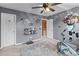 A bedroom is decorated with sports themes and a ceiling fan that creates an active space at 13132 Purple Dawn Dr, Charlotte, NC 28213