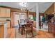 Open dining room with hardwood floors, elegant chandelier, and a view of the living room at 13132 Purple Dawn Dr, Charlotte, NC 28213