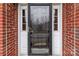 Close-up of a modern front door with glass panel and sidelights, set in a brick facade at 13132 Purple Dawn Dr, Charlotte, NC 28213