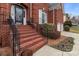 Charming brick home entrance with a stairway leading to the front door, framed by manicured bushes at 13132 Purple Dawn Dr, Charlotte, NC 28213