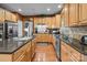 Updated kitchen featuring stainless steel appliances, granite countertops, and wooden cabinets at 13132 Purple Dawn Dr, Charlotte, NC 28213