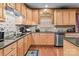 Well-lit kitchen featuring wooden cabinets, granite countertops, and stainless steel appliances at 13132 Purple Dawn Dr, Charlotte, NC 28213