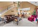 This is an inviting living room with a grand staircase and an open view into the bright kitchen at 13132 Purple Dawn Dr, Charlotte, NC 28213
