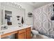 Well-lit bathroom with vanity, shower and tub combination, and decorative shower curtain at 157 Talbert Town Loop, Mooresville, NC 28117