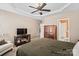 Spacious carpeted bedroom with a ceiling fan, a sitting area, and an en-suite bathroom at 157 Talbert Town Loop, Mooresville, NC 28117