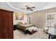This bedroom has a trey ceiling, neutral walls, natural light, and is furnished with a bed, chair, and accent table at 157 Talbert Town Loop, Mooresville, NC 28117