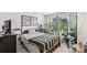 This bedroom features hardwood floors, natural light, and is furnished with a bed, desk, and shelving at 157 Talbert Town Loop, Mooresville, NC 28117