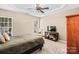 This bedroom boasts a trey ceiling, natural light, and is furnished with a comfortable bed and entertainment center at 157 Talbert Town Loop, Mooresville, NC 28117