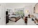 This bedroom features hardwood floors, natural light, and is furnished with a bed, desk, and shelving at 157 Talbert Town Loop, Mooresville, NC 28117