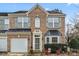 Beautiful brick townhome with manicured bushes and a one car garage at 157 Talbert Town Loop, Mooresville, NC 28117