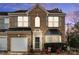Charming brick home with a two-car garage, manicured landscaping, and a welcoming front porch at 157 Talbert Town Loop, Mooresville, NC 28117