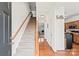 Inviting foyer with staircase, hardwood floors, and view into the living room at 157 Talbert Town Loop, Mooresville, NC 28117