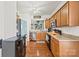 Well-lit kitchen featuring wood cabinets, stainless steel appliances, and hardwood floors at 157 Talbert Town Loop, Mooresville, NC 28117