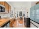 Open kitchen featuring wood cabinets, stainless steel appliances, and a breakfast nook with natural light at 157 Talbert Town Loop, Mooresville, NC 28117