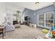 Inviting living room with large windows, a cozy fireplace, and plush carpet at 157 Talbert Town Loop, Mooresville, NC 28117