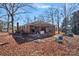 Charming brick home featuring a covered patio, mature trees, and a tranquil outdoor space at 1874 Mcilwain Rd, Lancaster, SC 29720