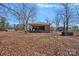 A quaint brick home with a covered patio and mature trees in a serene setting at 1874 Mcilwain Rd, Lancaster, SC 29720