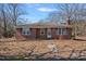 Charming brick home featuring symmetrical window placement and a well-maintained front yard at 1874 Mcilwain Rd, Lancaster, SC 29720