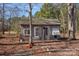 Outside view of a wooden shed with two doors, window, and surrounding trees at 1874 Mcilwain Rd, Lancaster, SC 29720