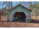 Image of an outbuilding with open entrance and overgrowth of leaves at 1874 Mcilwain Rd, Lancaster, SC 29720
