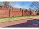 Spacious backyard featuring a brick privacy fence and a patterned patio at 1910 Connemara Ct, Gastonia, NC 28054