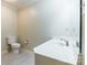 Bright bathroom featuring a white vanity, toilet, neutral paint, and tile flooring at 1910 Connemara Ct, Gastonia, NC 28054