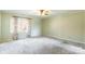 Spacious bedroom with large windows, neutral carpet, ceiling fan, and soft green walls at 1910 Connemara Ct, Gastonia, NC 28054