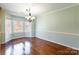 Charming dining room boasts hardwood floors, natural light, and elegant chandelier at 1910 Connemara Ct, Gastonia, NC 28054