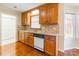 Well-maintained kitchen offers wood cabinets, neutral countertops, and a window over the sink at 1910 Connemara Ct, Gastonia, NC 28054