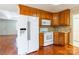 Efficient kitchen with ample cabinet space, white appliances, and access to dining area at 1910 Connemara Ct, Gastonia, NC 28054