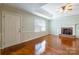 Inviting living room featuring a fireplace, hardwood floors, and a large window at 1910 Connemara Ct, Gastonia, NC 28054