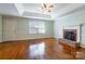 Inviting living room featuring a fireplace, hardwood floors, and a large window at 1910 Connemara Ct, Gastonia, NC 28054