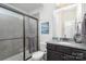 Modern bathroom with a tiled shower, granite countertop, dark cabinets and excellent lighting at 214 Blossom Ridge Dr, Mooresville, NC 28117