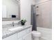 Well-lit bathroom with granite countertops, a decorative mirror, and a shower-tub combination at 2209 Lincolnshire Ln, Waxhaw, NC 28173