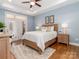 Cozy bedroom featuring tray ceilings, soft lighting, and French doors to the outside patio at 2209 Lincolnshire Ln, Waxhaw, NC 28173