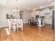 Open concept dining area flowing into a bright kitchen with white cabinets, a bar, and stainless steel appliances at 2209 Lincolnshire Ln, Waxhaw, NC 28173