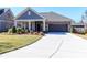Beautifully landscaped home with a two-car garage and a meticulously maintained lawn and concrete driveway at 2209 Lincolnshire Ln, Waxhaw, NC 28173