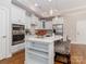 Bright kitchen with an island with bar seating, granite counters, and stainless steel appliances at 2209 Lincolnshire Ln, Waxhaw, NC 28173