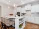 Bright kitchen featuring an island with bar seating, white cabinets and stainless steel appliances at 2209 Lincolnshire Ln, Waxhaw, NC 28173